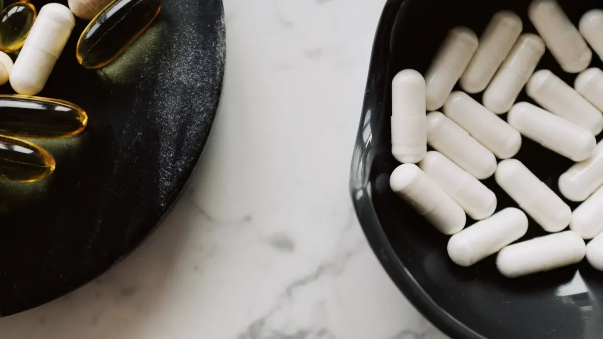 A bottle of dog chews sitting on a kitchen counter next to a wall calendar
