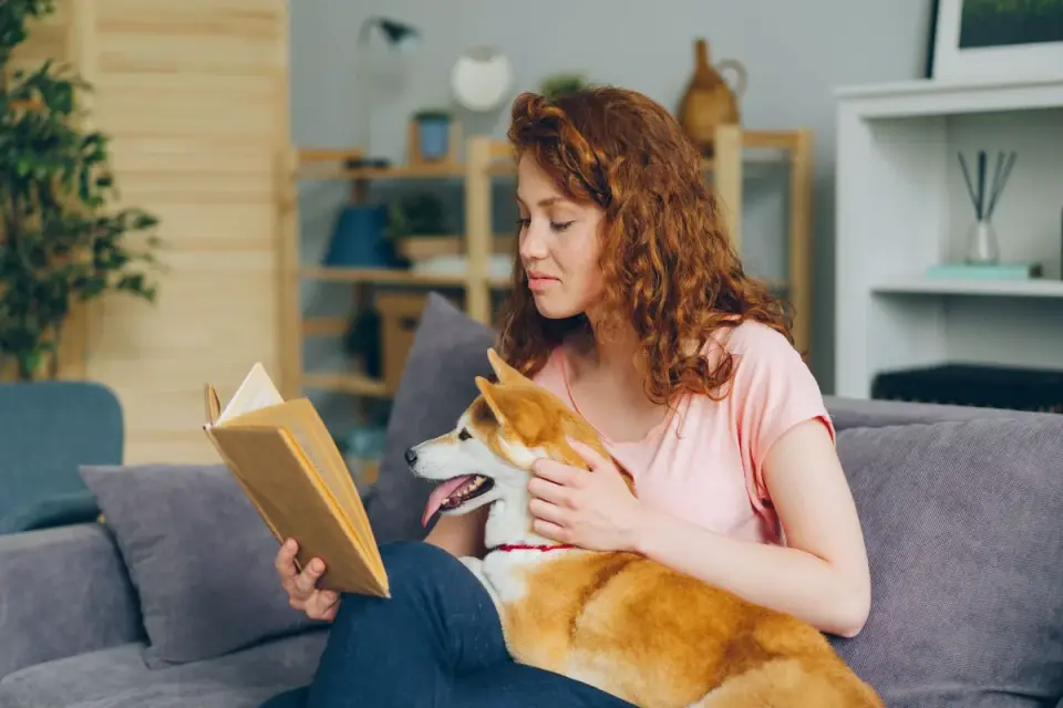 A pet owner reading the ingredient panel on a dog supplement label