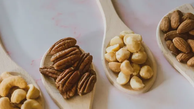 A small pile of shelled macadamia nuts spilled on a kitchen counter