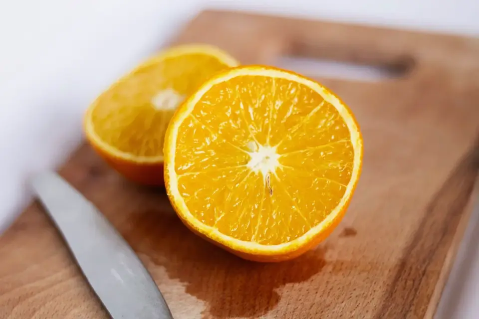A soft dog supplement chew cut in half on a small cutting board
