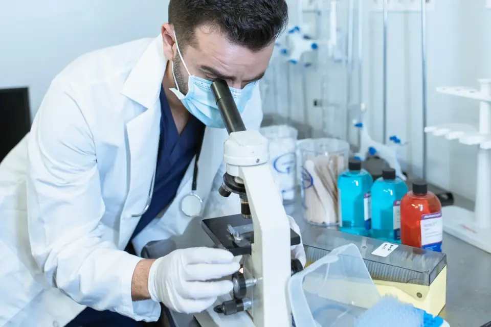 A veterinarian gently examining a young puppy on an exam table