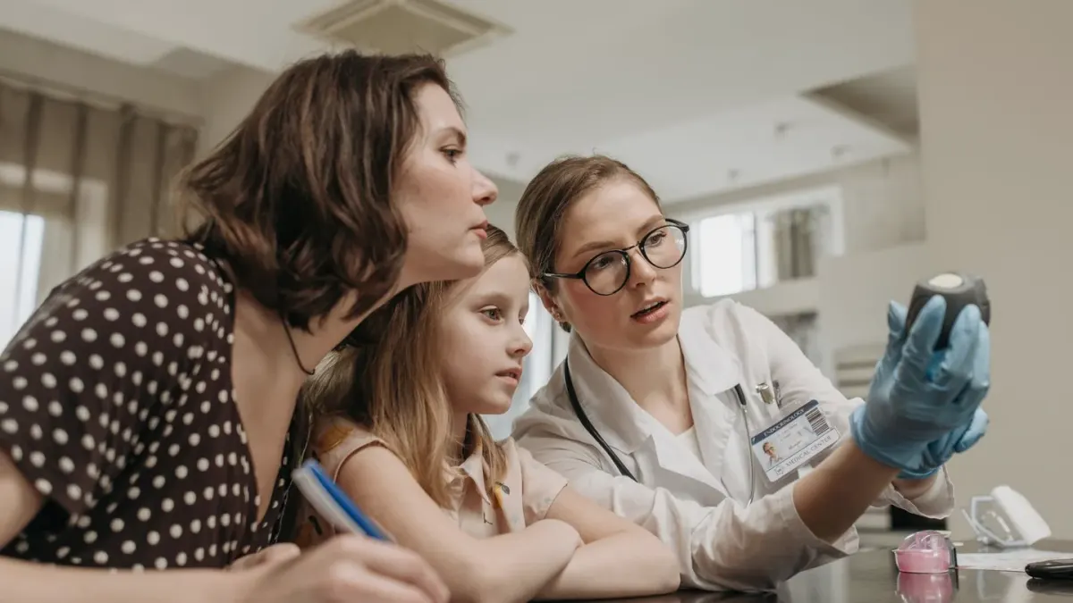 A veterinarian showing a supplement label to a dog owner during an exam room visit