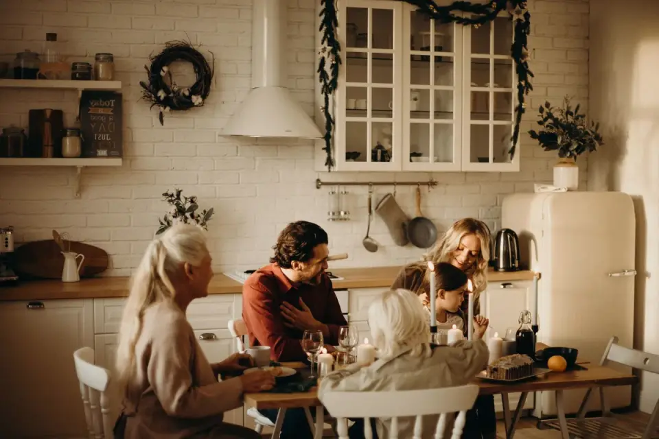 Dog sitting near a holiday dinner table waiting for scraps