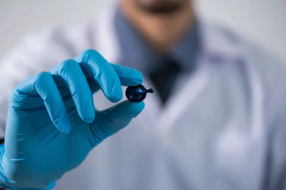 Lab technician examining supplement capsules for a quality control check