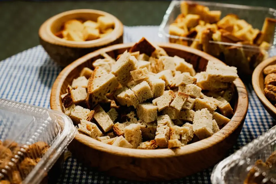 Small cubes of different cheeses arranged near a dog&#x27;s treat bowl