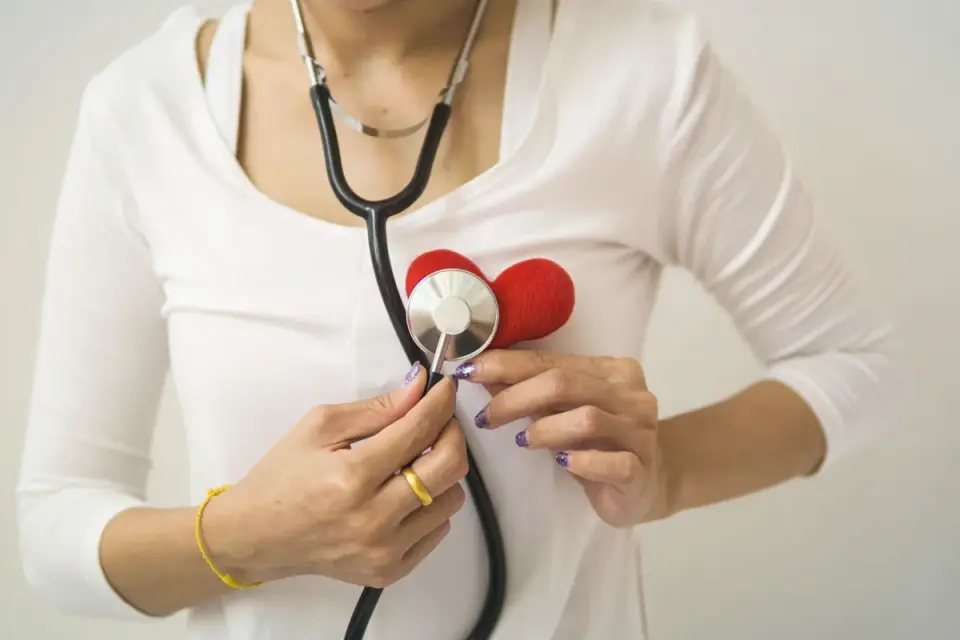 Veterinarian listening to a senior dog's heart with a stethoscope